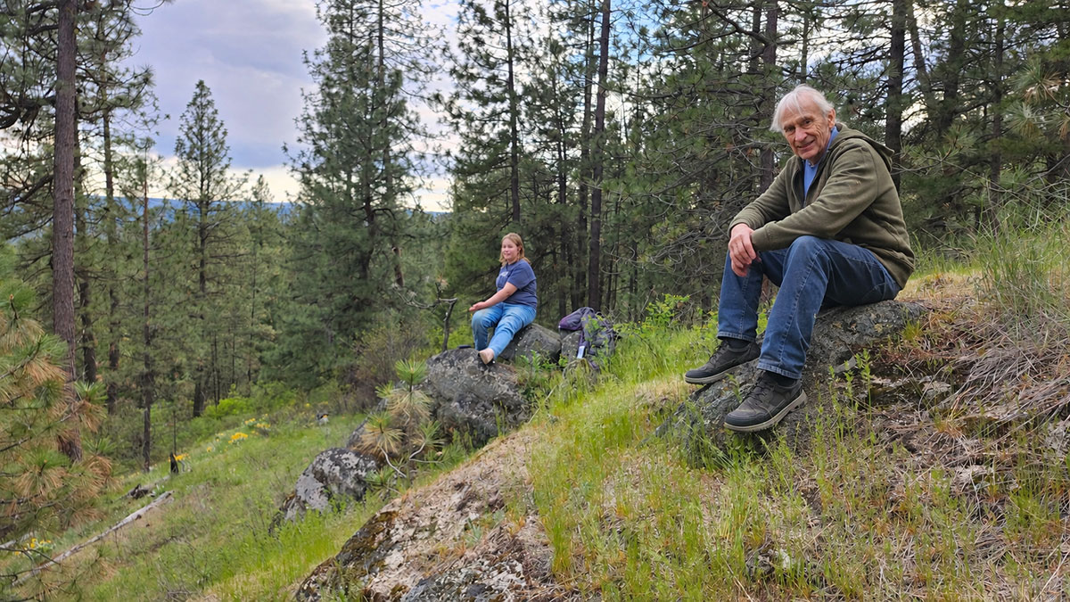 Guests resting on a forested hillside at Living Springs Ranch