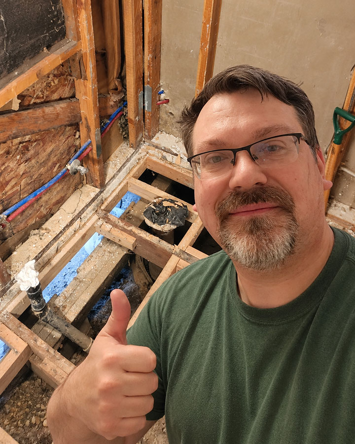 Blue Cabin bathroom renovation in progress with a thumbs-up