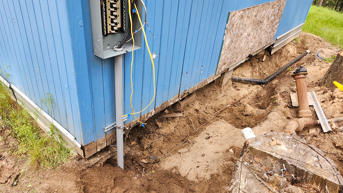 Digging and utility work beside the Blue Cabin
